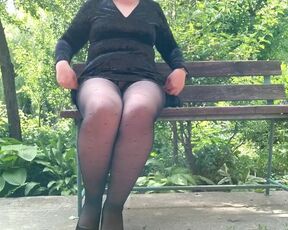 Naughty milf in pantyhose pissing in the park on a bench rear view