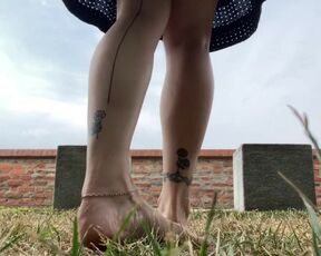 Barefoot milf prancing around in grass, soles close ups, foot fetish