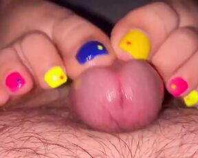 Tickling teasing colourful neon toes rubbing on a big head